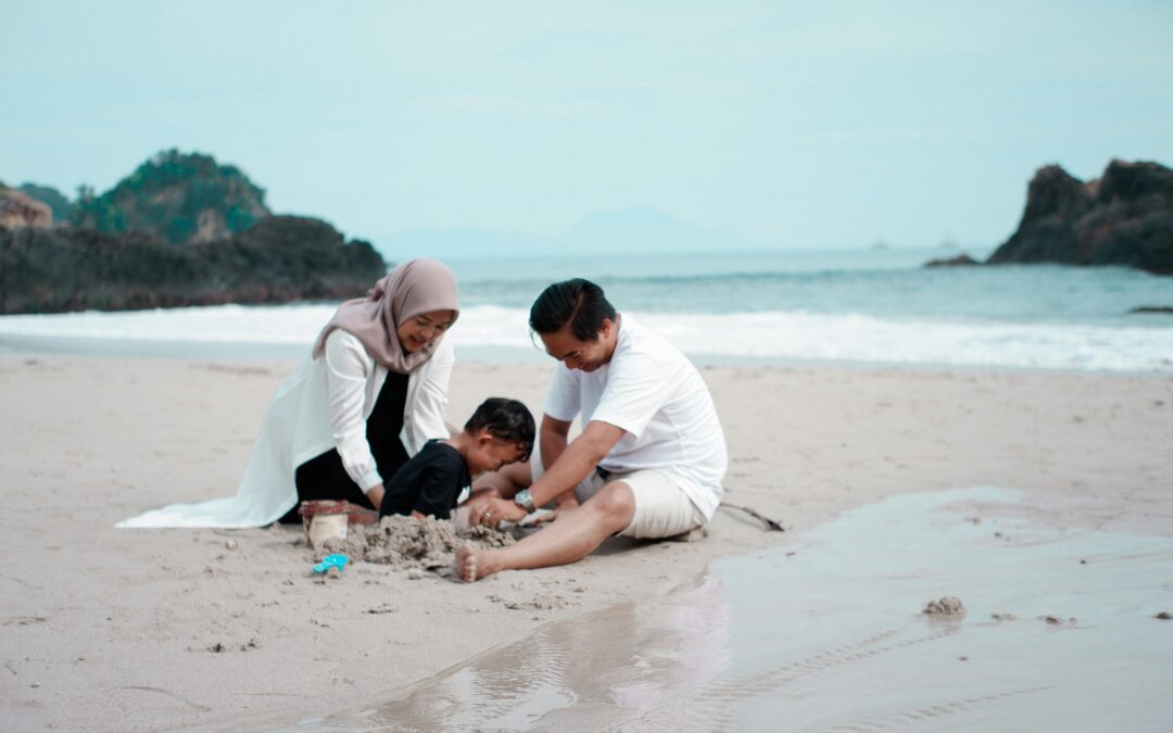 A family sitting at the beach after visiting the Rodney health clinic